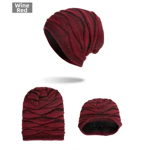 Detailed view of wine red knitted beanie with thick black fleece lining and warm texture