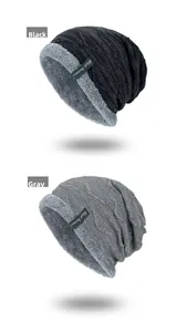Detail of knitted beanie with thick grey fleece lining in black and grey colors