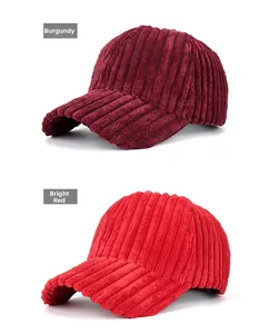 Detailed close-up of corduroy baseball caps in burgundy and bright red colors