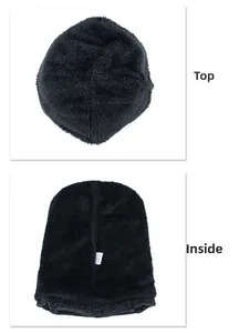 Detailed view of black knitted beanie featuring thick fleece lining and material tag