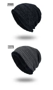 Detail of warm knitted beanie hats in black and gray with thick plush fleece lining