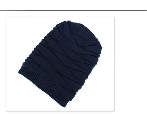 Detailed close-up of dark blue knit beanie showing wavy texture and ribbed cuff design