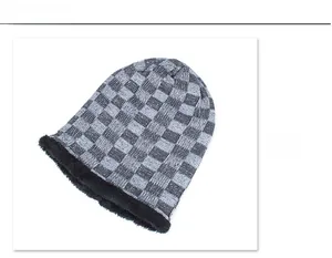 Detail view of winter beanie showing checkered pattern and thick black fleece lining