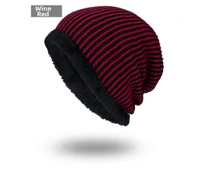 Close-up of wine red knit beanie with thick black fleece lining and striped texture