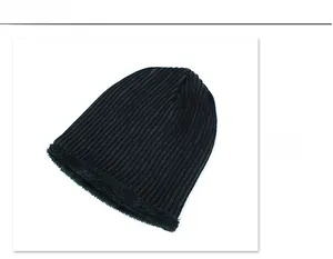 Detail view showing black ribbed knit exterior and thick warm faux fur lining of the beanie