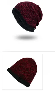 Detail view of winter wine red knitted beanie with thick black faux fur lining inside