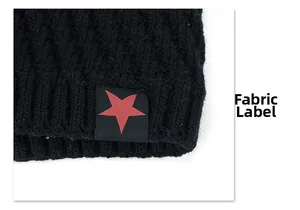 Close-up of black knitted beanie texture with a red five-point star cloth tag detail