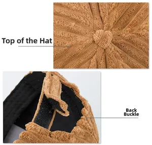 Detail of caramel striped corduroy baseball cap showing top button and velcro back closure