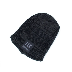 Black distressed knit beanie with ribbed texture and streetwear ripped hole details