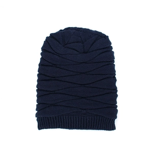Men's winter knit beanie in navy blue with warm fleece lining and textured wave design