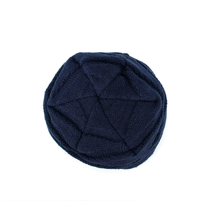 Top view of dark blue knit beanie featuring diamond texture and round crown construction