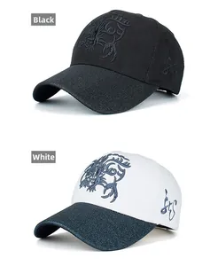 Detail of cotton baseball caps with dragon embroidery in black and white colors