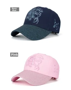 Detailed embroidery on cotton baseball caps with glitter brim in navy and pink