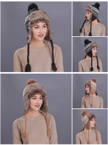 Detailed close-up of a winter trapper hat with knit patterns and faux fur lining