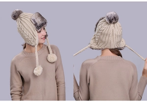 Detailed side and back view of a beige cable-knit trapper hat with gray faux fur lining