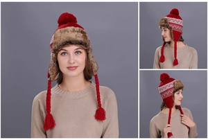 Detail of red winter knit hat with white patterns and plush brown faux fur trim