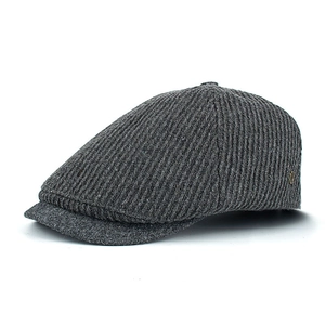 Detail of dark grey wool blend flat cap featuring vertical stripes and metal logo