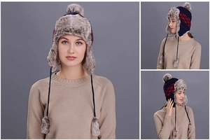 Detailed view of plush lining and star pattern on knit trapper hat with pom poms
