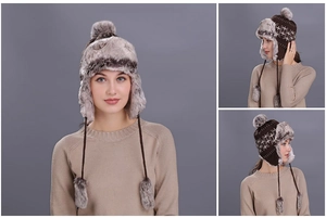 Detail of winter trapper hat with snowflake patterns, grey faux fur lining and pompom ties