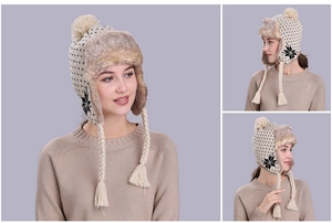 Detailed view of beige knitted winter trapper hat with fur lining and snowflake patterns