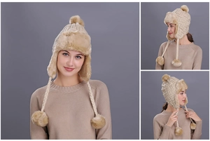 Detail of winter knit trapper hat with khaki faux fur lining and plush pom-poms