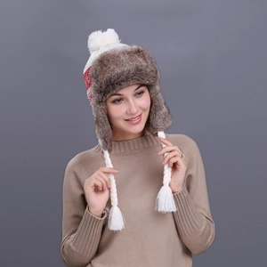 Winter knitted trapper hat with white pompom, red wave patterns and brown faux fur lining