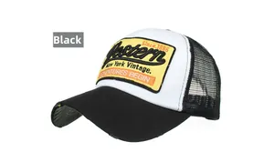 Close-up of vintage mesh trucker hat with distressed brim and yellow embroidered patch