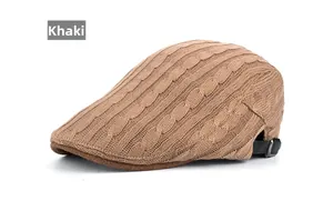 Detailed close-up of khaki cable-knit beret featuring adjustable leather back strap