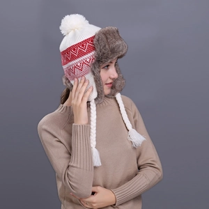 Winter knitted earflap trapper hat with red and white pattern and faux fur lining