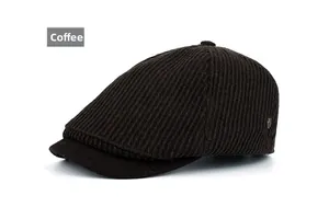 Detail view of coffee brown newsboy cap with vertical ribbed texture and side metal stud