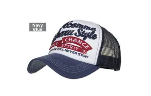 Detailed close-up of navy blue trucker hat featuring premium 3D embroidery and mesh back