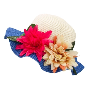 Detail view of woven straw sun hat with navy blue brim and large colorful flowers