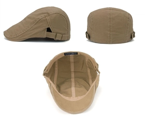 Detail view of khaki cotton newsboy cap showing stitching, side strap, and metal buckle