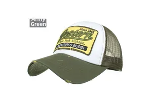 Detail of army green trucker hat featuring vintage Western embroidery and mesh back