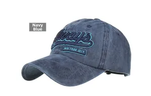Detail of navy blue baseball cap featuring Always embroidery and New York City patch