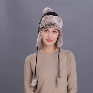 Winter knitted earflap trapper hat with gray faux fur lining and plush pom poms