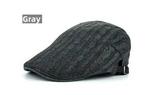 Detail of grey cable knit texture and metal buckle adjustment on the casual peaked cap