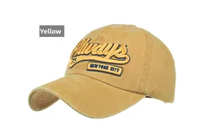 Close-up of Always embroidery and vintage blue patches on yellow cotton baseball cap