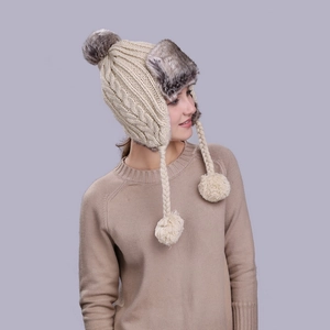 Winter cable knit earflap trapper hat in beige with faux fur lining and pom-poms