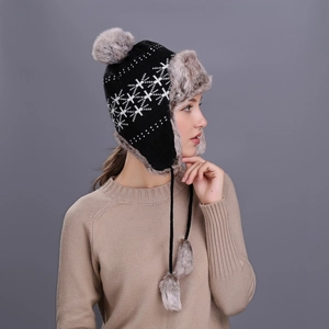 Winter knit trapper hat with snowflake patterns and grey faux fur trim for women