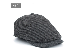 Detail view of a dark grey striped wool beret cap with a metal logo at a 45-degree angle