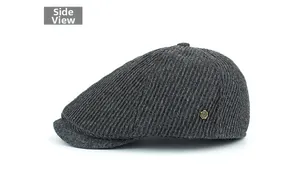 Close-up of charcoal grey striped wool newsboy cap with vintage metal side badge