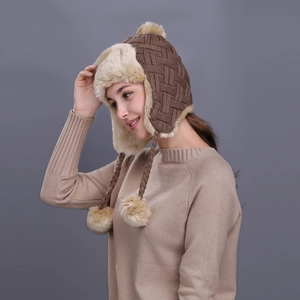 Winter checkered knit trapper hat with faux fur lining and plush pom-poms in brown