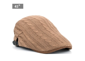 Detail view of cable knit peaked cap featuring an adjustable black strap at the back