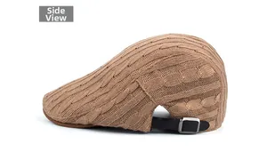 Detail of cable knit pattern and leather back strap with metal buckle on beret cap