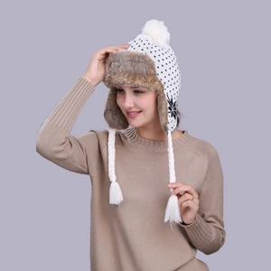 Winter snowflake knit trapper hat with brown faux fur lining and pompom detail