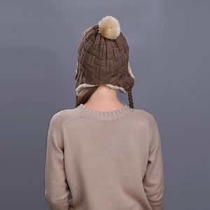 Winter checkered knit trapper hat with faux fur lining and pompom shown from back
