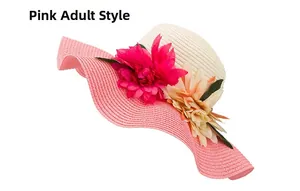 Detail view of woven straw hat featuring pink wavy brim and artificial flower decorations