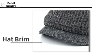 Detail of dark grey winter cap showing thick twill wool fabric and reinforced brim texture