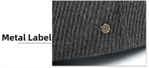 Detail of grey wool newsboy cap showing vertical stripe texture and metal W logo
